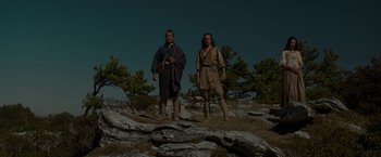 Movie still from “The Last of the Mohicans” (1992), directed by Michael Mann – Two native americans standing on top of a rocky hill; Wide shot, Low angle