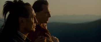 Movie still from “The Last of the Mohicans” (1992), directed by Michael Mann – Two men standing next to each other on top of a hill; Close Up shot, Low angle