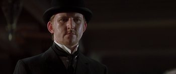Movie still from “The League of Extraordinary Gentlemen” (2003), directed by Stephen Norrington – A person wearing a suit and a hat; Close Up shot, Low angle