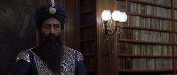 Movie still from “The League of Extraordinary Gentlemen” (2003), directed by Stephen Norrington – A man with a long beard wearing a turban and standing in front of a book case; Close Up shot, Low angle