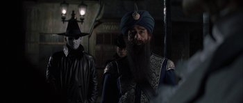 Movie still from “The League of Extraordinary Gentlemen” (2003), directed by Stephen Norrington – A man with a long beard wearing a blue turban; Medium shot, Over the shoulder angle
