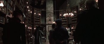Movie still from “The League of Extraordinary Gentlemen” (2003), directed by Stephen Norrington – A group of people standing inside of a library; Wide shot, Low angle