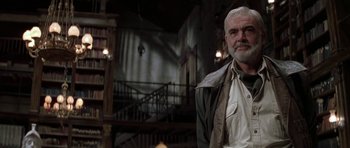 Movie still from “The League of Extraordinary Gentlemen” (2003), directed by Stephen Norrington – An older man standing in front of a staircase; Medium shot, Low angle