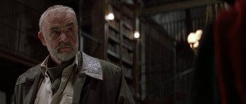 Movie still from “The League of Extraordinary Gentlemen” (2003), directed by Stephen Norrington – An older man wearing a jacket in a room with bookshelves; Close Up shot, Low angle