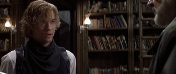 Movie still from “The League of Extraordinary Gentlemen” (2003), directed by Stephen Norrington – A man standing in front of a book shelf; Close Up shot, Over the shoulder angle