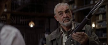 Movie still from “The League of Extraordinary Gentlemen” (2003), directed by Stephen Norrington – An older man holding a gun while wearing a jacket; Close Up shot, Low angle