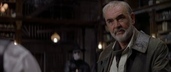 Movie still from “The League of Extraordinary Gentlemen” (2003), directed by Stephen Norrington – An older man with a beard and mustache wearing glasses and wearing a hat; Close Up shot, Low angle