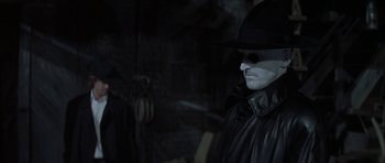 Movie still from “The League of Extraordinary Gentlemen” (2003), directed by Stephen Norrington – A man in a black hat and a leather jacket; Close Up shot, Over the shoulder angle