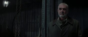 Movie still from “The League of Extraordinary Gentlemen” (2003), directed by Stephen Norrington – An older man standing in front of a brick wall; Close Up shot, Over the shoulder angle