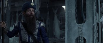 Movie still from “The League of Extraordinary Gentlemen” (2003), directed by Stephen Norrington – A man with a long beard wearing a blue turban; Medium shot, Over the shoulder angle