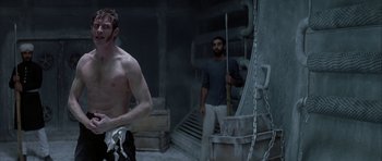 Movie still from “The League of Extraordinary Gentlemen” (2003), directed by Stephen Norrington – Two men standing in a room with a ladder; Medium shot, Low angle