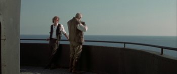 Movie still from “The League of Extraordinary Gentlemen” (2003), directed by Stephen Norrington – Two men standing on a pier looking out at the ocean; Wide shot, Low angle