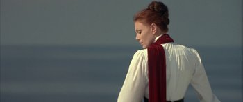Movie still from “The League of Extraordinary Gentlemen” (2003), directed by Stephen Norrington – A woman wearing a white shirt and a red scarf; Medium shot, Low angle
