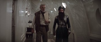 Movie still from “The League of Extraordinary Gentlemen” (2003), directed by Stephen Norrington – A man and a man with a beard standing next to each other; Medium shot, Low angle