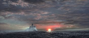 Movie still from “The League of Extraordinary Gentlemen” (2003), directed by Stephen Norrington – A person on top of a boat in the ocean at sunset; Extreme Wide shot, High angle