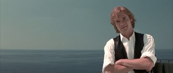 Movie still from “The League of Extraordinary Gentlemen” (2003), directed by Stephen Norrington – A man standing in front of a body of water with his arms crossed; Close Up shot, Low angle