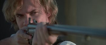 Movie still from “The League of Extraordinary Gentlemen” (2003), directed by Stephen Norrington – A person holding a rifle; Close Up shot, Over the shoulder angle