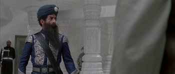 Movie still from “The League of Extraordinary Gentlemen” (2003), directed by Stephen Norrington – A man with long hair and a long beard wearing a hat; Medium shot, Low angle