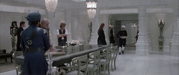 Movie still from “The League of Extraordinary Gentlemen” (2003), directed by Stephen Norrington – A group of people standing around a dining room table; Wide shot, High angle