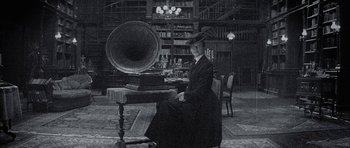 Movie still from “The League of Extraordinary Gentlemen” (2003), directed by Stephen Norrington – A woman sitting in front of an old fashioned gramophone; Medium shot, Low angle