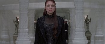 Movie still from “The League of Extraordinary Gentlemen” (2003), directed by Stephen Norrington – A woman with long red hair wearing a black dress; Medium shot, Low angle
