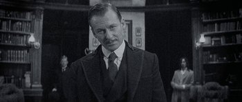 Movie still from “The League of Extraordinary Gentlemen” (2003), directed by Stephen Norrington – An older man wearing a suit and tie; Close Up shot, Low angle