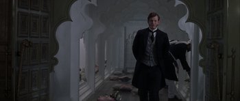 Movie still from “The League of Extraordinary Gentlemen” (2003), directed by Stephen Norrington – A man in a suit and tie standing in a hallway; Wide shot, Low angle