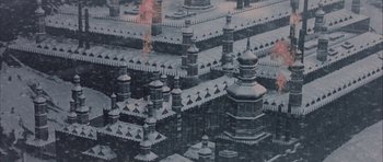 Movie still from “The League of Extraordinary Gentlemen” (2003), directed by Stephen Norrington – An aerial view of a building with a fire in the middle of it; Extreme Wide shot, High angle