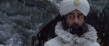 Movie still from “The League of Extraordinary Gentlemen” (2003), directed by Stephen Norrington – A man with a beard and a white turban is in the rain; Close Up shot, Low angle