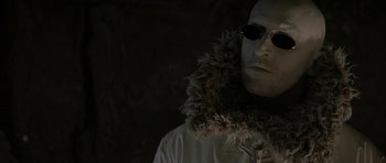 Movie still from “The League of Extraordinary Gentlemen” (2003), directed by Stephen Norrington – A man wearing sunglasses and a furry collar; Close Up shot, Low angle