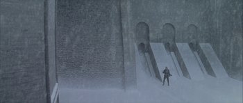Movie still from “The League of Extraordinary Gentlemen” (2003), directed by Stephen Norrington – A man standing in the snow next to a ramp; Extreme Wide shot, High angle