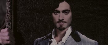 Movie still from “The League of Extraordinary Gentlemen” (2003), directed by Stephen Norrington – A painting of a man in a suit and beard; Close Up shot, Overhead angle