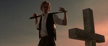 Movie still from “The League of Extraordinary Gentlemen” (2003), directed by Stephen Norrington – A young man holding onto a large wooden stick; Medium shot, Low angle
