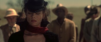 Movie still from “The League of Extraordinary Gentlemen” (2003), directed by Stephen Norrington – A woman wearing a black hat and a red scarf; Close Up shot, Low angle