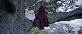 Movie still from “The Legend of Tarzan” (2016), directed by David Yates – A man and a woman sitting on a tree; Wide shot, Low angle