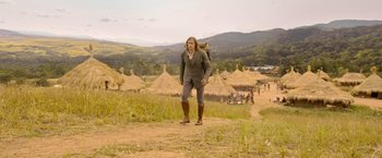 Movie still from “The Legend of Tarzan” (2016), directed by David Yates – A woman in a field with a backpack; Wide shot, Over the shoulder angle