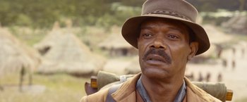 Movie still from “The Legend of Tarzan” (2016), directed by David Yates – An older man with a hat and a backpack; Close Up shot, Over the shoulder angle