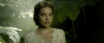Movie still from “The Legend of Tarzan” (2016), directed by David Yates – A beautiful woman in a white dress looking at the camera; Close Up shot, Over the shoulder angle