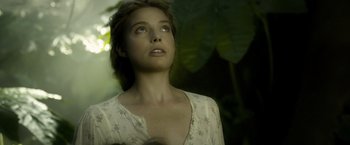 Movie still from “The Legend of Tarzan” (2016), directed by David Yates – A beautiful young woman looking up at the sky; Close Up shot, Low angle