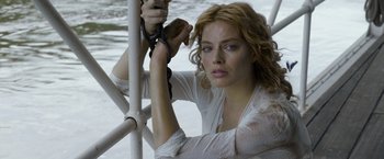 Movie still from “The Legend of Tarzan” (2016), directed by David Yates – A beautiful woman holding a pair of shears; Close Up shot, High angle