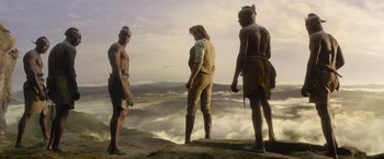 Movie still from “The Legend of Tarzan” (2016), directed by David Yates – A group of men standing on top of a mountain; Wide shot, Low angle