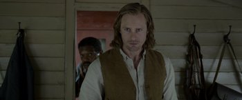 Movie still from “The Legend of Tarzan” (2016), directed by David Yates – A man with long hair standing in front of another man; Close Up shot, Over the shoulder angle
