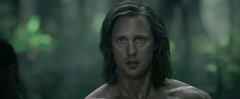 Movie still from “The Legend of Tarzan” (2016), directed by David Yates – A person with long brown hair; Close Up shot, Over the shoulder angle