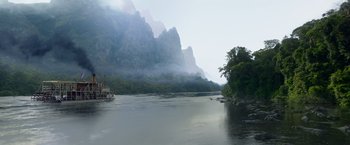Movie still from “The Legend of Tarzan” (2016), directed by David Yates – A boat on a body of water near some mountains; Extreme Wide shot, High angle