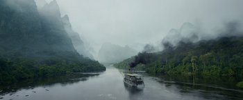 Movie still from “The Legend of Tarzan” (2016), directed by David Yates – A boat traveling down a river surrounded by mountains; Extreme Wide shot, High angle