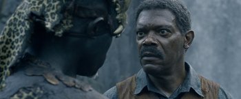 Movie still from “The Legend of Tarzan” (2016), directed by David Yates – A man in a leather vest and a man in a leather vest; Close Up shot, Over the shoulder angle