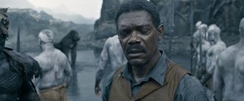 Movie still from “The Legend of Tarzan” (2016), directed by David Yates – An old man is standing in the rain; Close Up shot, Over the shoulder angle