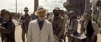 Movie still from “The Legend of Tarzan” (2016), directed by David Yates – A man in a white suit and a white hat; Medium shot, Low angle