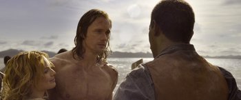 Movie still from “The Legend of Tarzan” (2016), directed by David Yates – Two men standing next to each other near the ocean; Medium shot, Over the shoulder angle