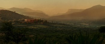 Movie still from “The Legend of Zorro” (2005), directed by Martin Campbell – A view of a mountain range with a house in the distance; Extreme Wide shot, High angle